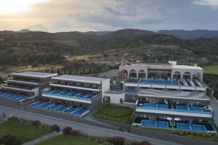 Exterior of hotel and mountains behind